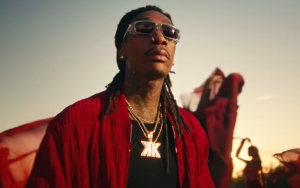 Wiz Khalifa Fondled by Red Clothed Women in 'Bad A** B***hes' Visuals