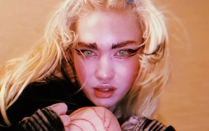 Grimes Shows Off 'Alien Scars' Tattoo and Chipped Tooth