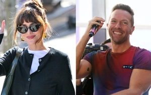 Dakota Johnson and Chris Martin Appear to Have Serious Conversation at Glastonbury