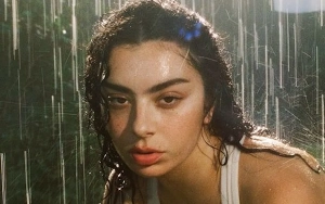 Charli XCX Braves the Rain in Wet Outfit for New SKIMS Campaign