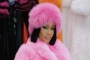 Saweetie Dresses Up as Christmas Gift in Plastic Dress With Big Ribbons