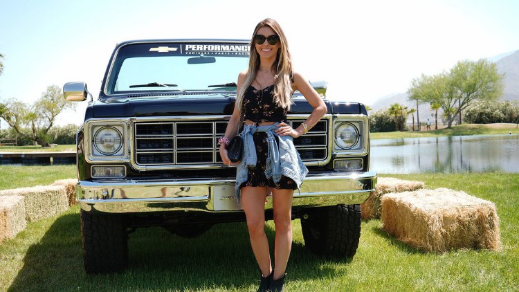 Audrina Patridge poses in front of a Chevrolet car