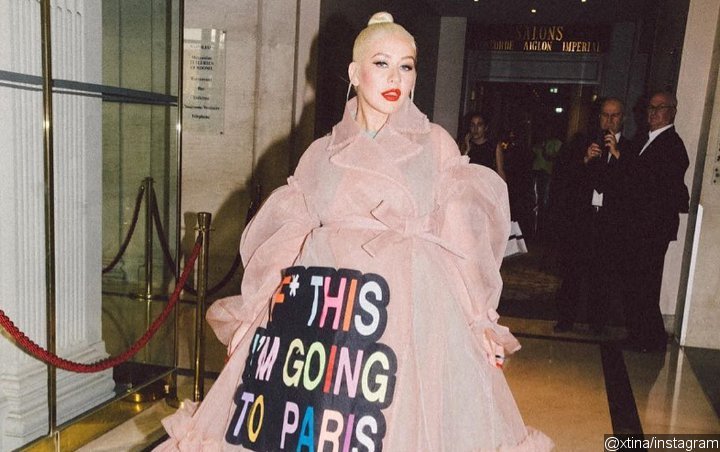 Christina Aguilera Puts on Sweary Oversized Trenchcoat for Paris Couture Week