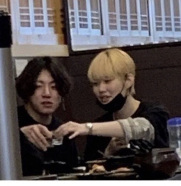 The BTS member is picture having drinks with tattoo artist Lee Mijoo. 