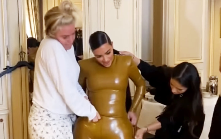Watch: Kim Kardashian's Skintight Latex Outfit Gives Her a Real Struggle