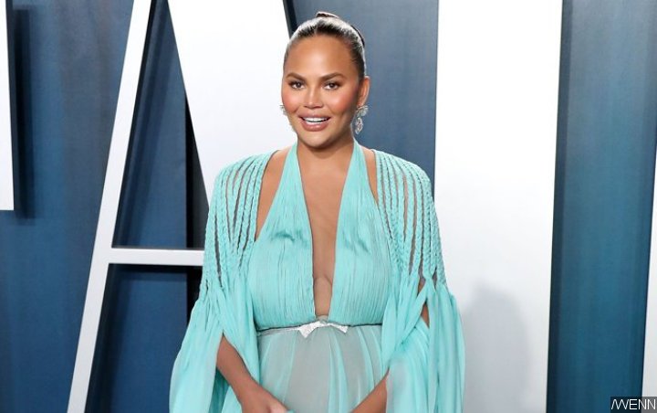 Chrissy Teigen Takes Pride in Her Non-'Surgically Enhanced Curves