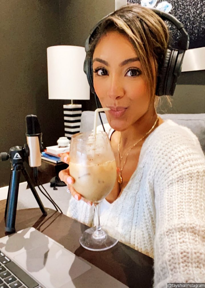 Tayshia Adams shared a picture of her donning a diamond ring