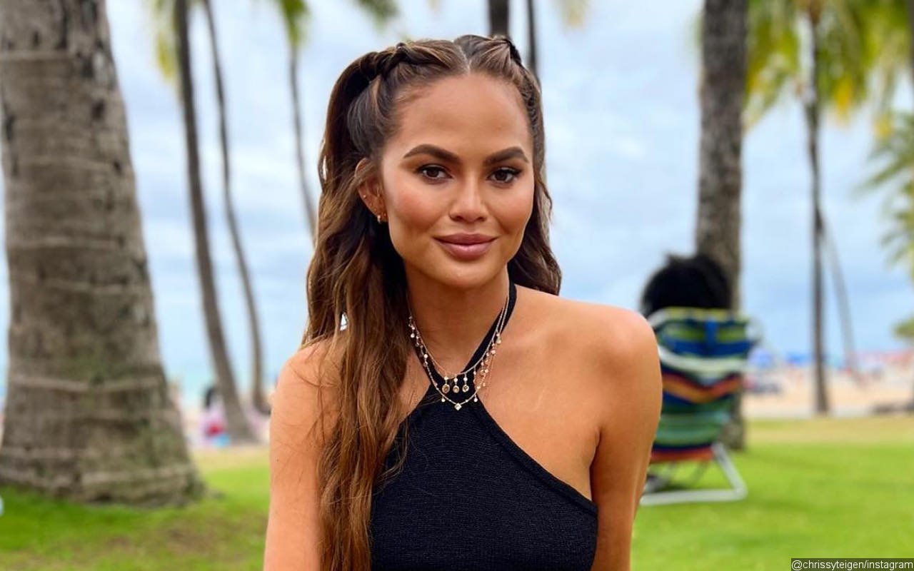 Chrissy Teigen Almost Bares All to Show Off Scar From Breast Implant Removal Surgery