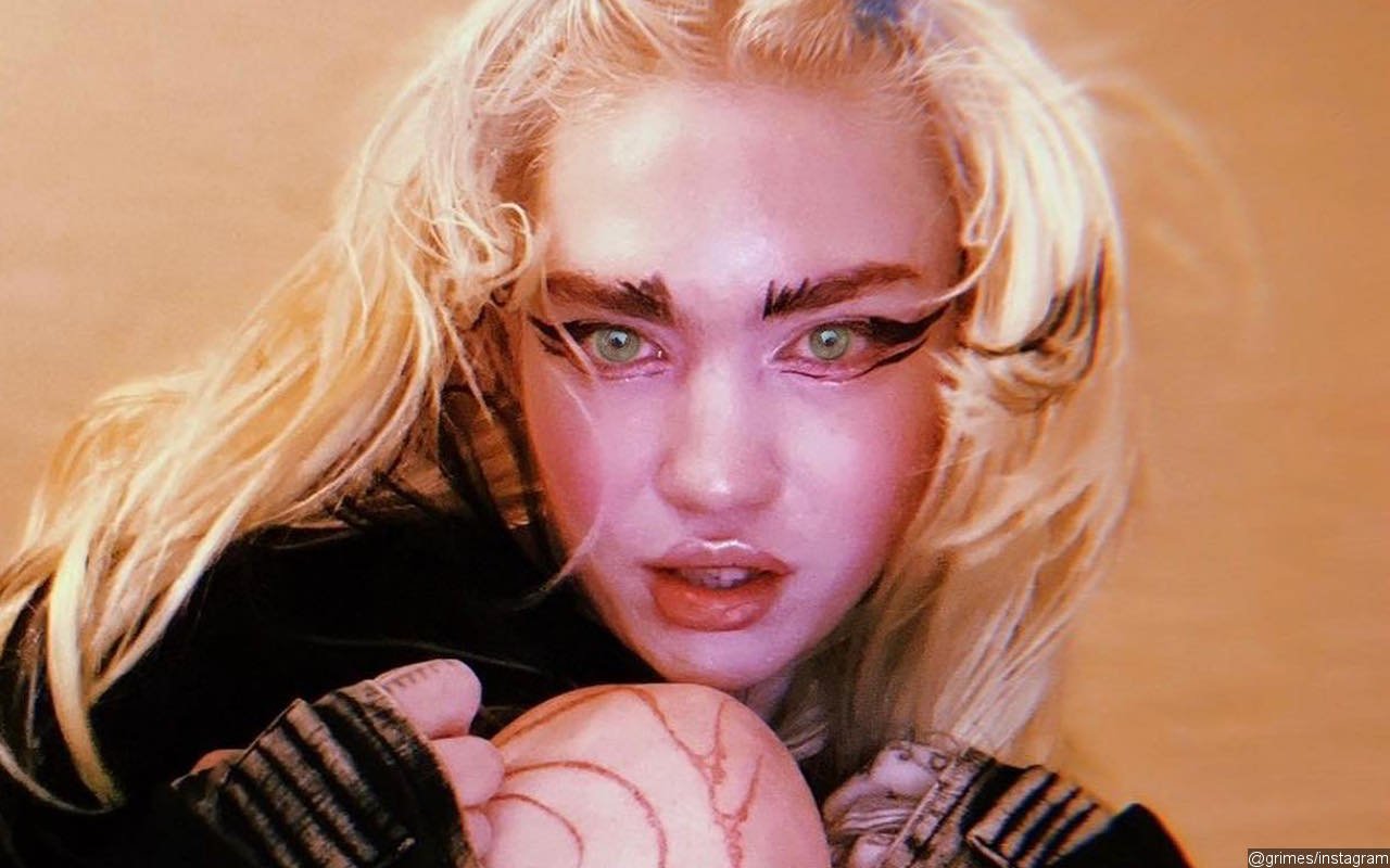 Grimes Shows Off 'Alien Scars' Tattoo and Chipped Tooth