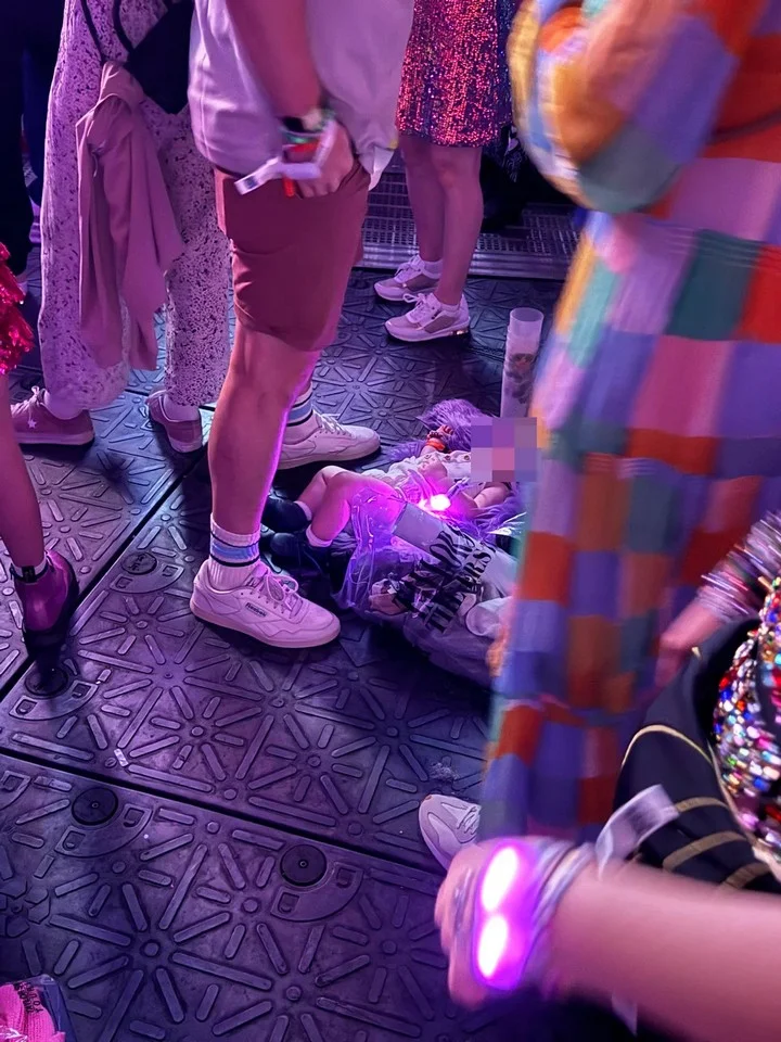 A baby is seen left on the floor in the standing room of Taylor Swift's concert in Paris