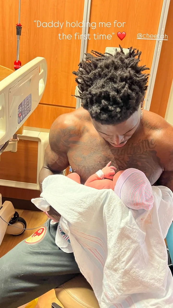 Tyreek Hill holds his newborn daughter