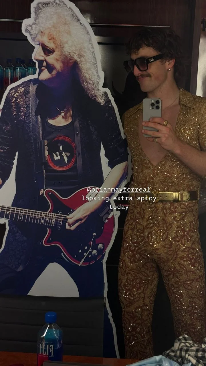 Benson Boone poses with Brian May cardboard cutout