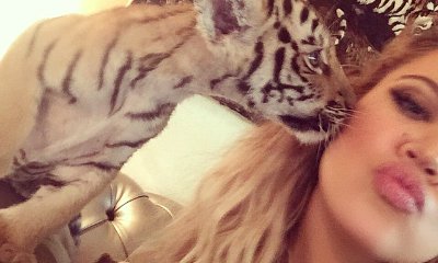 Khloe Kardashian Criticized After Posing With Tiger Cub During a Dubai Trip