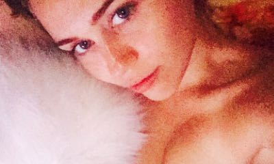 Miley Cyrus Shows Off Her Boob While Striking a Pose With Her Kitty