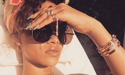 Rihanna Wears Tiny Yellow Bikini and Flashy Jewelry While Sunbathing in Barbados