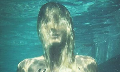 Heidi Klum Ditches Bikini Top for a Swim in These Steamy Photos