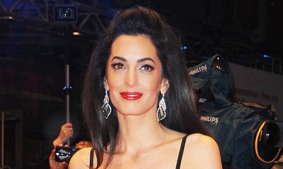 Amal Clooney Hides Belly in Baggy Jumper Amid Pregnancy Rumors
