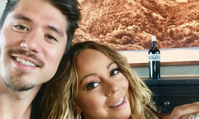 Mariah Carey Flaunts Ample Cleavage as She Cuddles Up to Bryan Tanaka