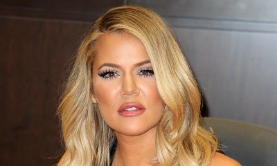 Khloe Kardashian Hides Any Sign of Baby Bump by Carrying Clothes on Hangers