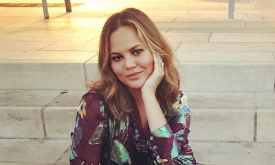 Chrissy Teigen Offers to Give Away Her Dress After Skipping Oscars