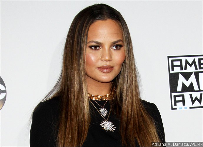 Chrissy Teigen Hilariously Responds to Fans Criticizing Her Daring AMA Dress