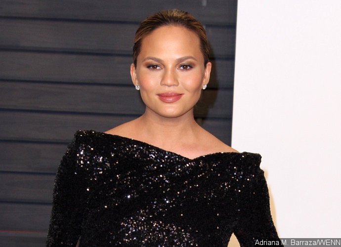 Chrissy Teigen Exposed! Model Flashes Nipples in Black Panel Dress