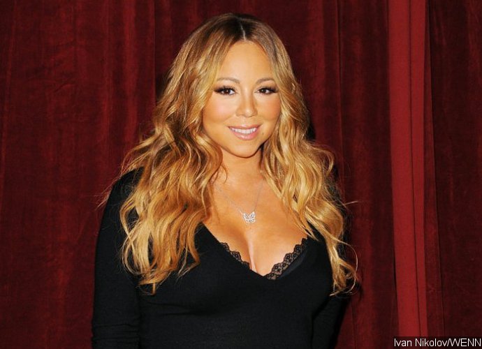 Mariah Carey Poses Nearly Naked Next to a Huge Christmas Tree During Holiday in Aspen