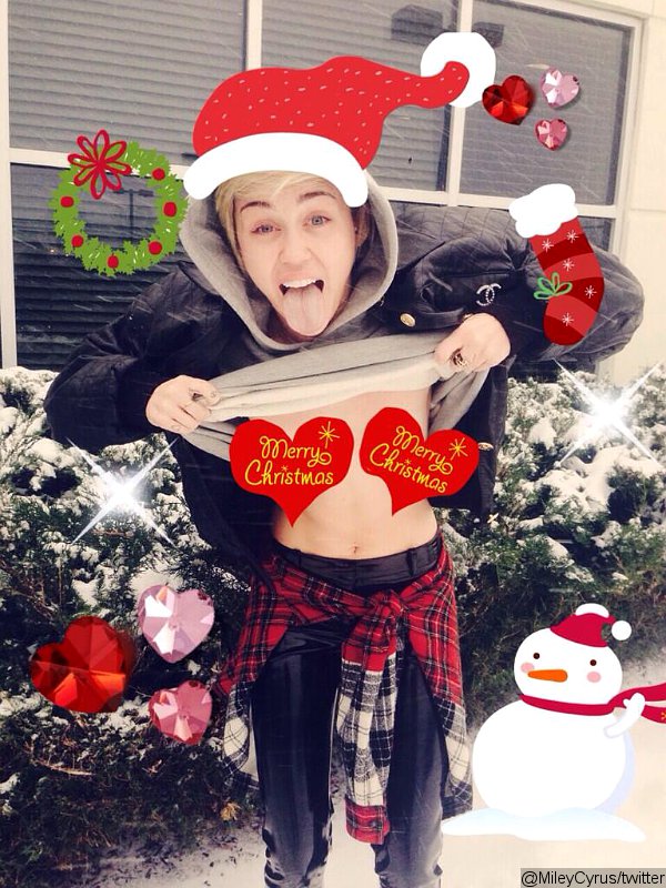 Miley Cyrus in Christmas outfit showing nipples