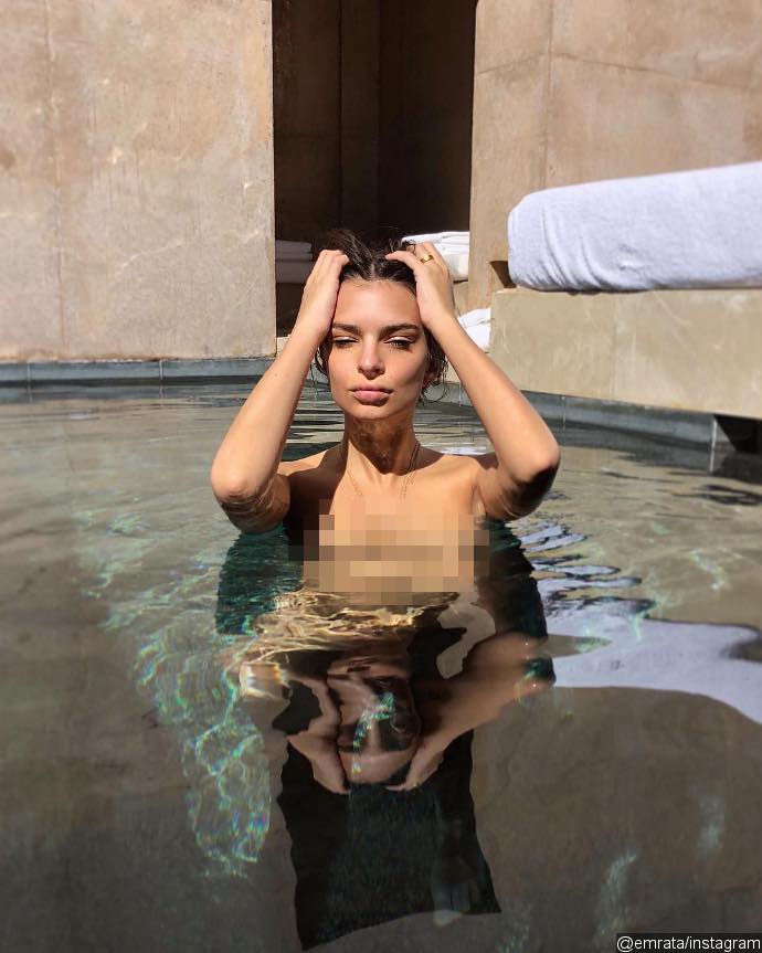 Emily Ratajkowski Poses Topless While Flashing Wedding Ring in Steamy Pool Snap