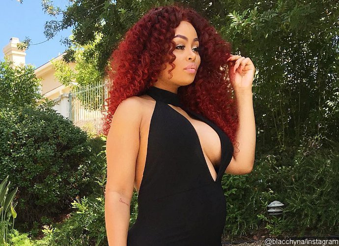 Pregnant Blac Chyna Shows Off Major Cleavage and Red Curly Hair