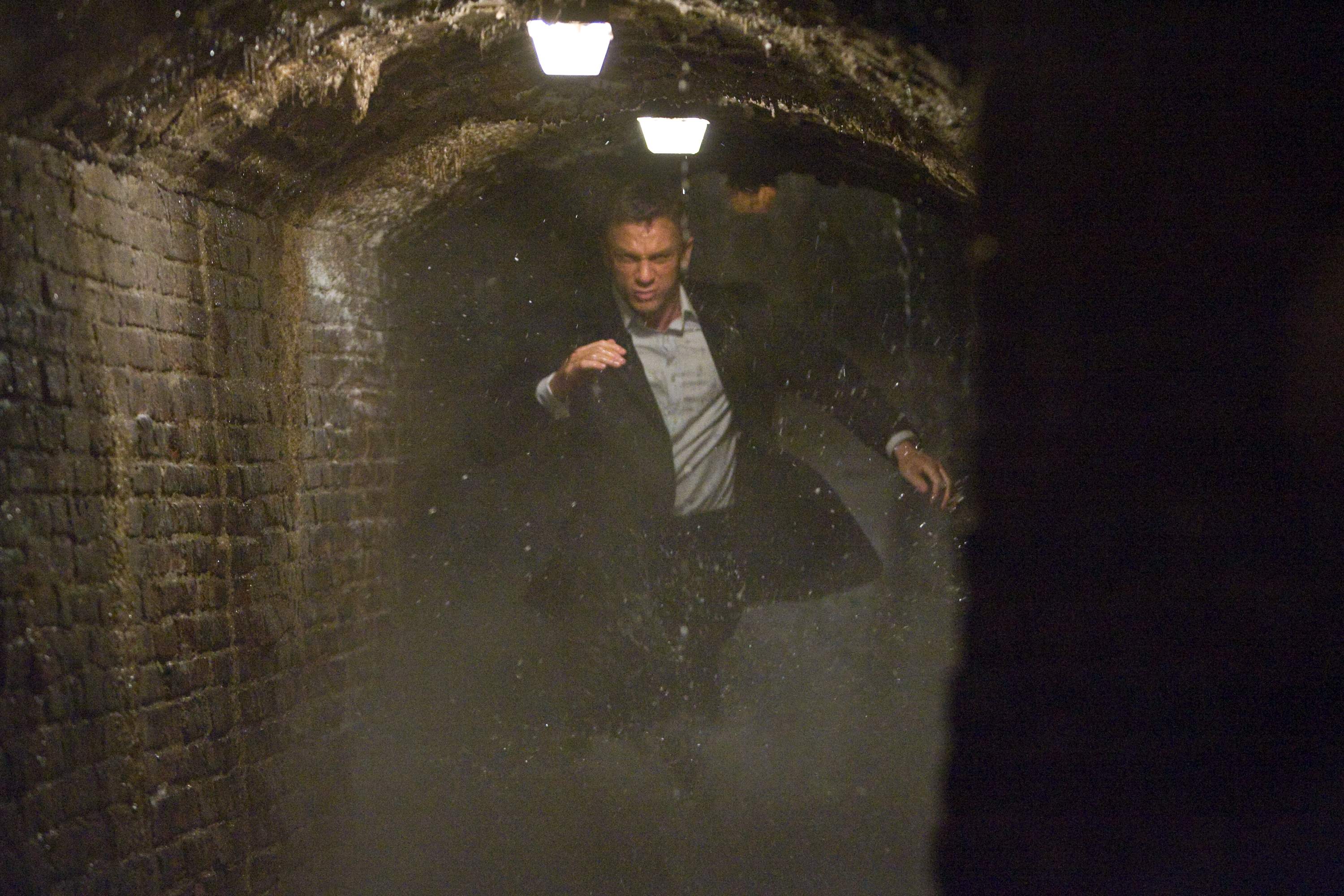 James Bond (DANIEL CRAIG) charges through the underground cisterns of Sienna in pursuit of an Mi6 traitor. Location: Pinewood Studios, Buckinghamshire, UK. Photo by: Karen Ballard.