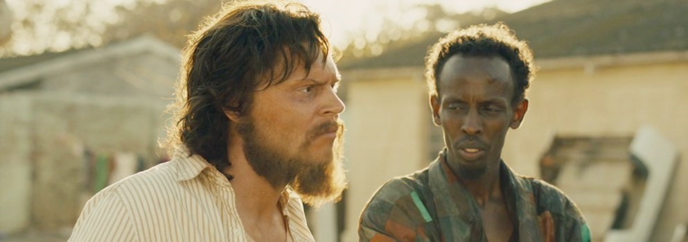 Evan Peters stars as Jay Bahadur and Barkhad Abdi stars as Abdi in Echo Bridge's The Pirates of Somalia (2017)