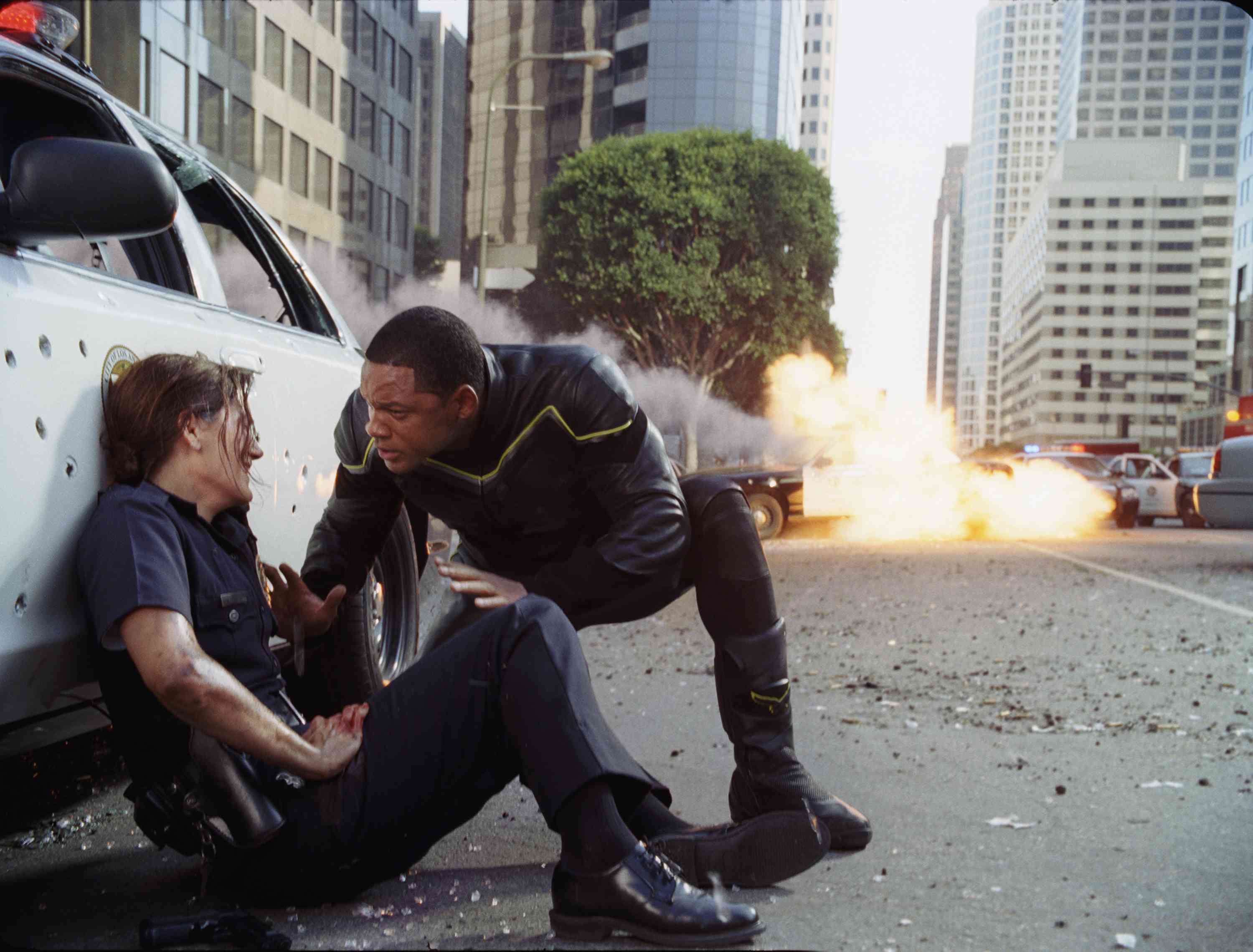 Hancock (Will Smith, right) saves the life of an injured female cop (Liz Wicker, left) before taking out a gang of heavily armed bank robbers in Columbia Pictures' Hancock. Photo credit: Courtesy of Columbia Pictures Industries, Inc.
