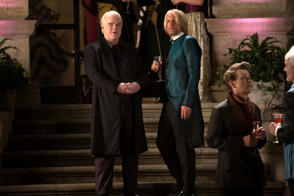 Philip Seymour Hoffman stars as Plutarch Heavensbee and Woody Harrelson stars as Haymitch Abernathy in Lionsgate Films' The Hunger Games: Catching Fire (2013)