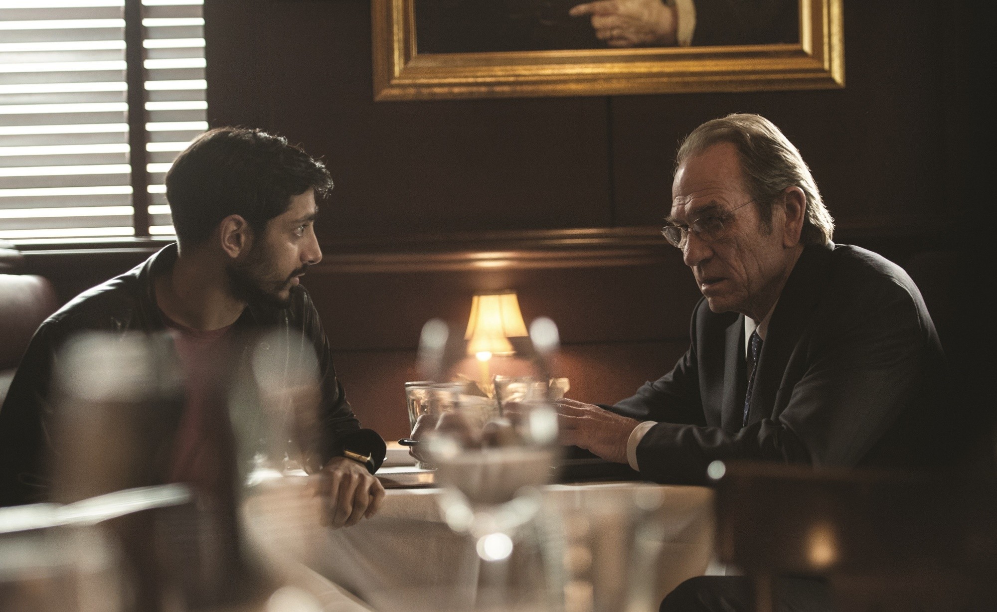 Riz Ahmed stars as Aaron Kalloor and Tommy Lee Jones stars as CIA Director Robert Dewey in Universal Pictures' Jason Bourne (2016)