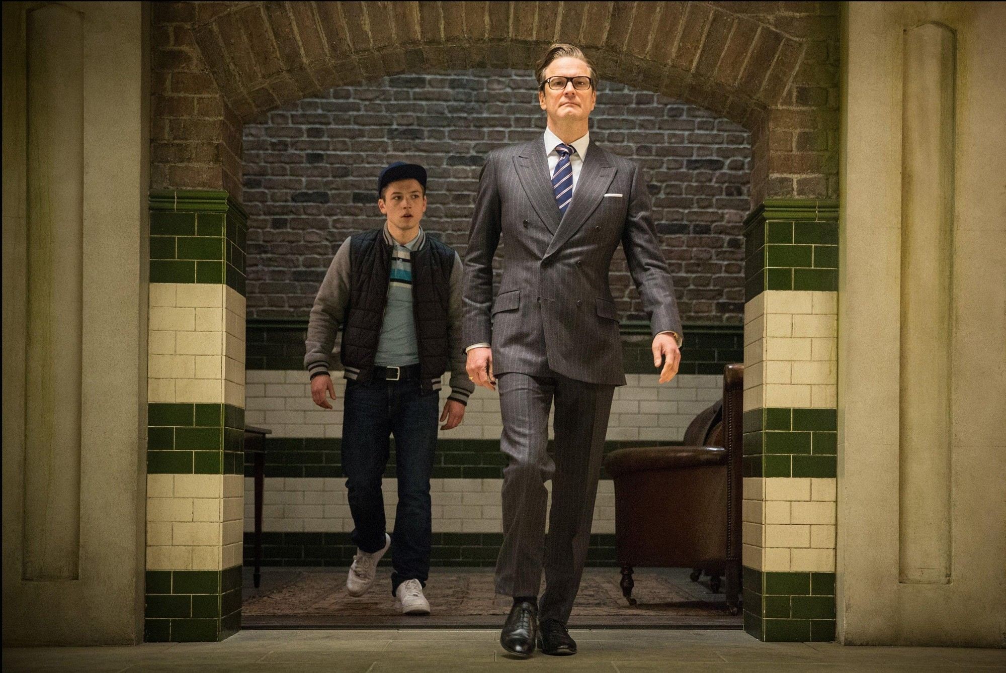 Taron Egerton stars as Gary Unwin and Colin Firth stars as Harry Hart/Galahad in 20th Century Fox's Kingsman: The Secret Service (2015)