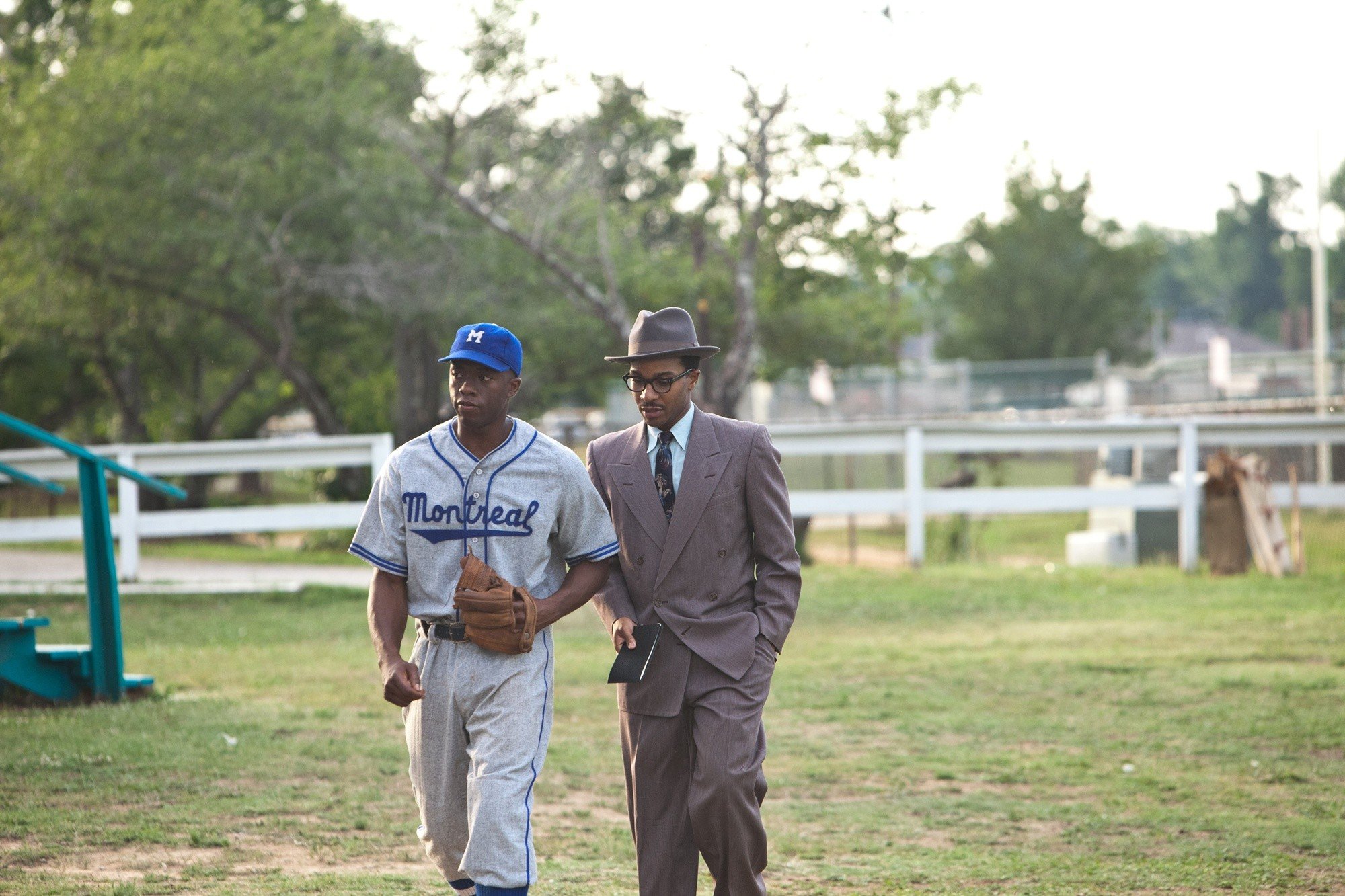 Chadwick Boseman stars as Jackie Robinson and Andre Holland stars as Wendell Smith in Warner Bros. Pictures' 42 (2013)
