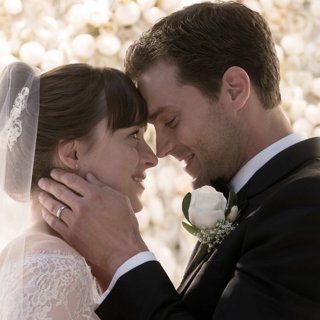 Dakota Johnson stars as Anastasia Steele and Jamie Dornan stars as Christian Grey in Universal Pictures' Fifty Shades Freed (2018)