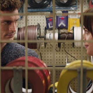 Jamie Dornan stars as Christian Grey and Dakota Johnson stars as Anastasia Steele in Focus Features' Fifty Shades of Grey (2015)