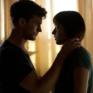 Jamie Dornan stars as Christian Grey and Dakota Johnson stars as Anastasia Steele in Focus Features' Fifty Shades of Grey (2015)