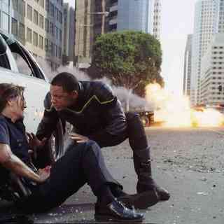 Hancock (Will Smith, right) saves the life of an injured female cop (Liz Wicker, left) before taking out a gang of heavily armed bank robbers in Columbia Pictures' Hancock. Photo credit: Courtesy of Columbia Pictures Industries, Inc.