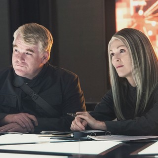 Philip Seymour Hoffman stars as Plutarch Heavensbee and Julianne Moore stars as President Alma Coin in Lionsgate Films' The Hunger Games: Mockingjay, Part 1 (2014)