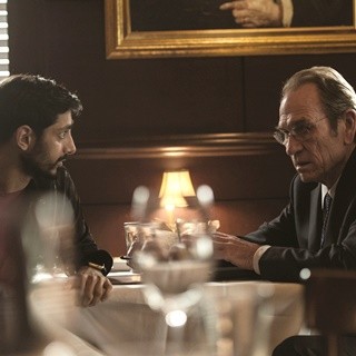 Riz Ahmed stars as Aaron Kalloor and Tommy Lee Jones stars as CIA Director Robert Dewey in Universal Pictures' Jason Bourne (2016)