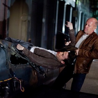 Joseph Gordon-Levitt stars as Joe and Bruce Willis stars as Older Joe in TriStar Pictures' Looper (2012)