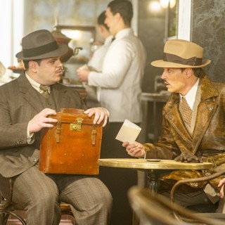 Josh Gad stars as Hector MacQueen and Johnny Depp stars as Ratchett in 20th Century Fox's Murder on the Orient Express (2017)