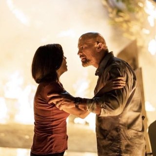 Neve Campbell stars as Sarah Sawyer and The Rock stars as Will Sawyer in Universal Pictures' Skyscraper (2018)