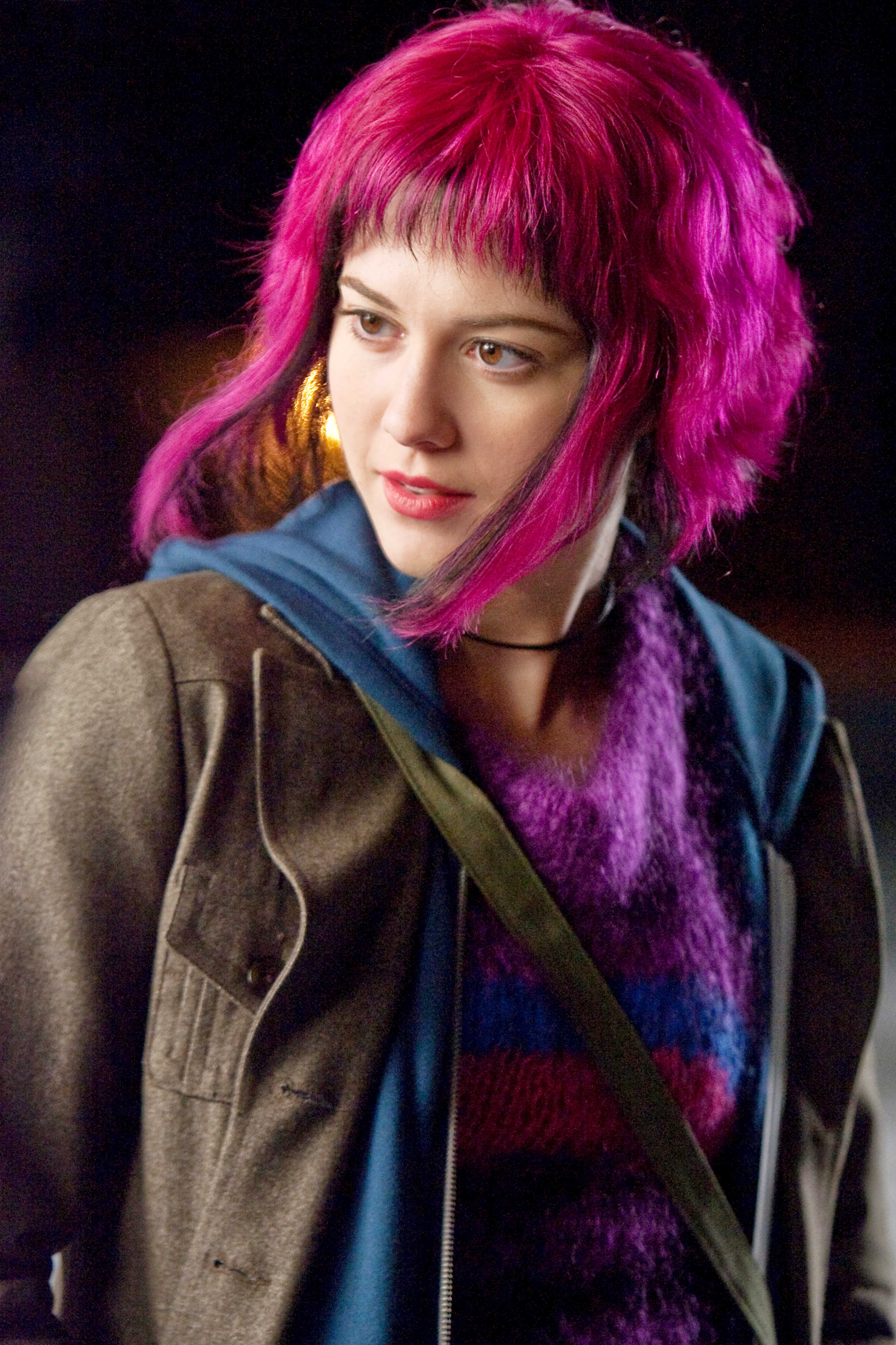 picture of Ramona Flowers, a white woman with fuscia pink hair, wearing a purple jumper with blue and pink stripes, from the film Scott Pilgrim vs the World https://www.aceshowbiz.com/images/still/scott_pilgrim_vs_the_world43.jpg
