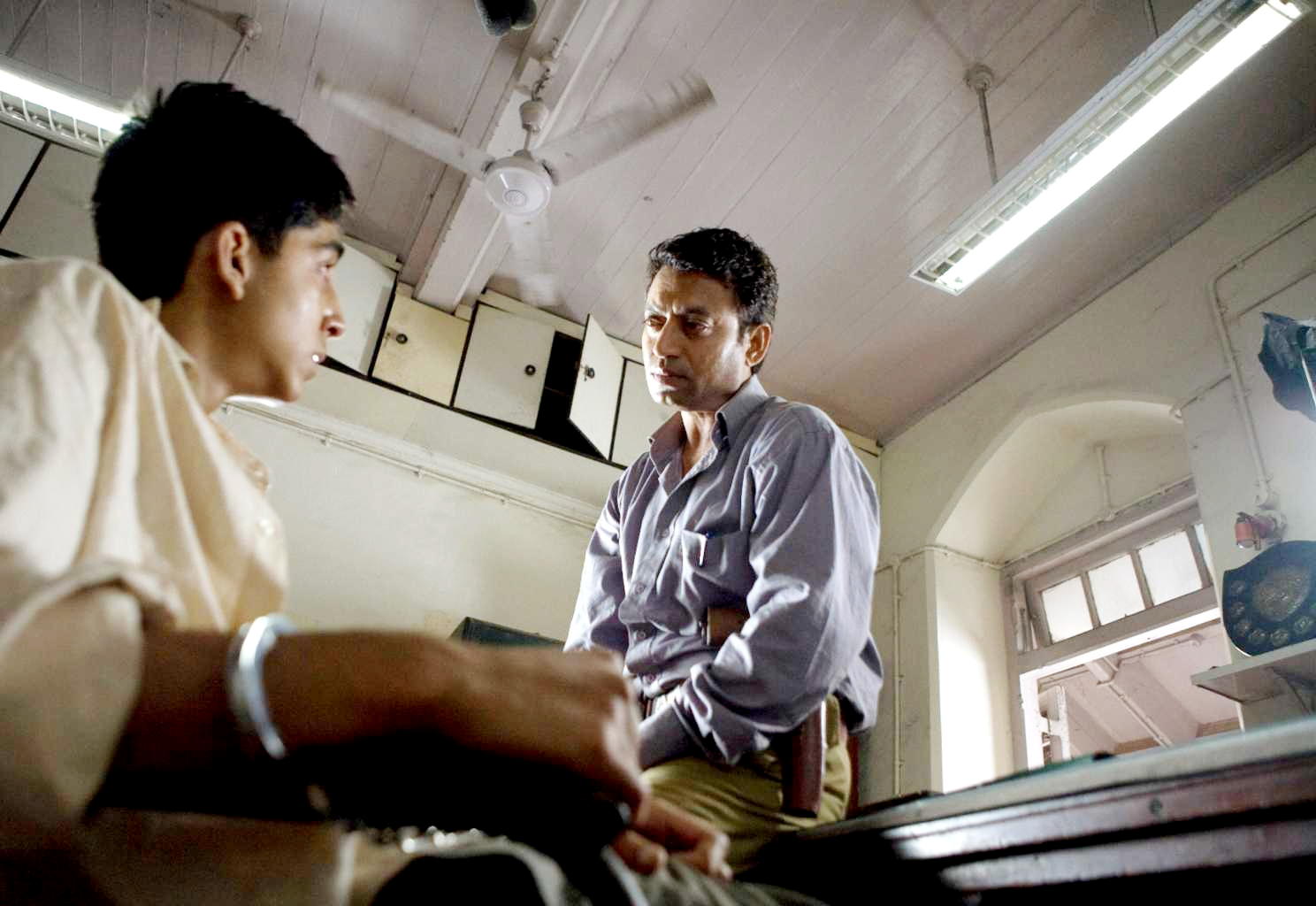 Dev Patel stars as Jamal Malik and Irfan Khan stars as Police Inspector in Fox Searchlight Pictures' Slumdog Millionaire (2008). Photo credit by Ishika Mohan.