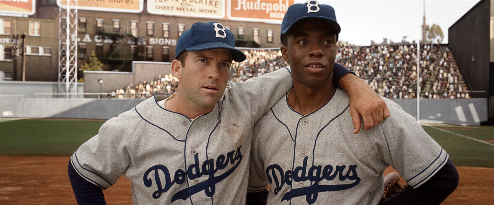 Lucas Black stars as Pee Wee Reese and Chadwick Boseman stars as Jackie Robinson in Warner Bros. Pictures' 42 (2013)