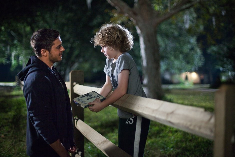 Zac Efron stars as Logan Thibault and Riley Thomas Stewart stars as Ben Clayton in Warner Bros. Pictures' The Lucky One (2012)